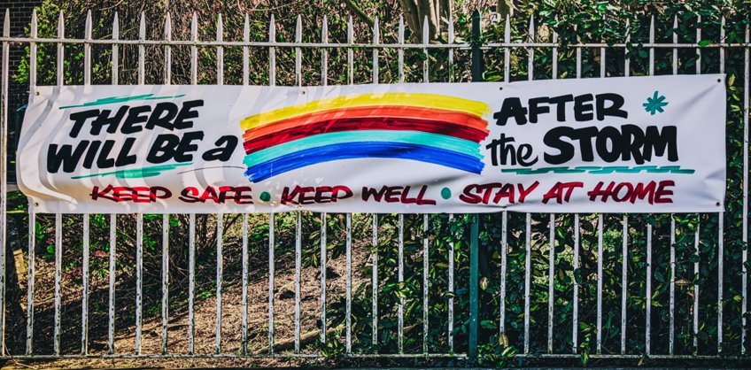 Outdoor sign that says "There will be a rainbow after the storm. Keep safe. Keep well. Stay at Home."