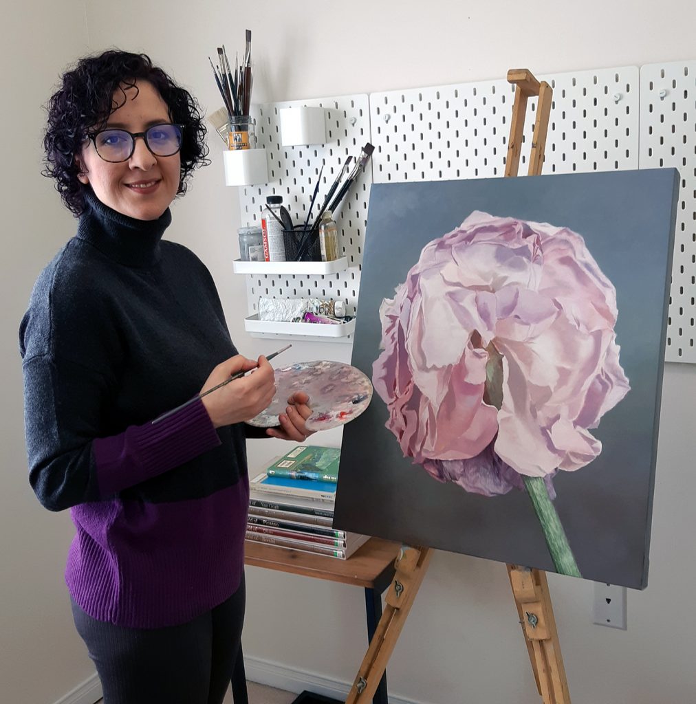 Maryam Shafiei pictured with her art work: a painting of a pink flower