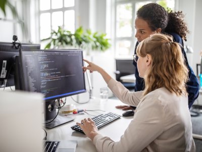 Two people in front of a computer