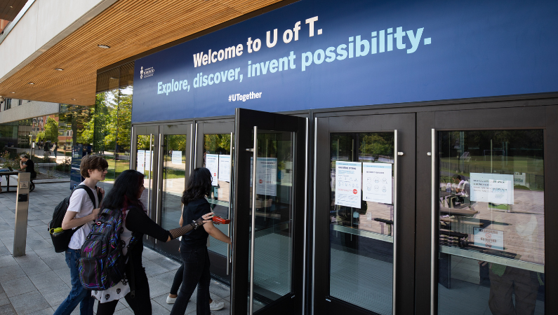 Banner above a door with text, "Welcome to U of T. Explore, discover, invent possibility."