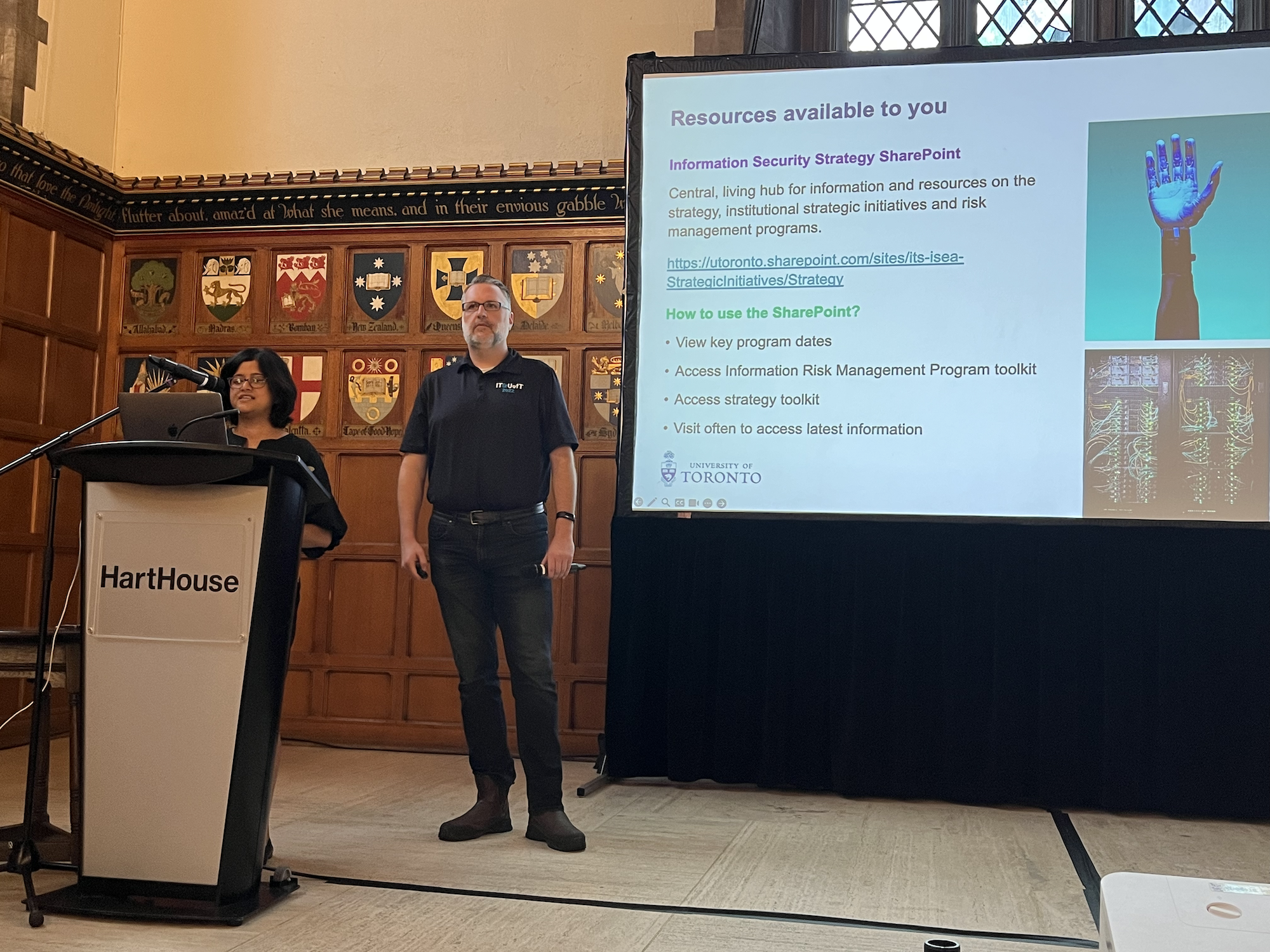 Isaac and Kalyani presenting on stage at the Town Hall.