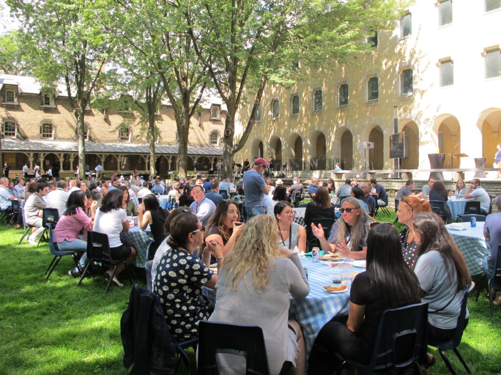 Staff sitting around tables, talking and eating