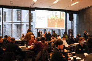 Participants sitting in round tables at the ITS all-staff meeting.
