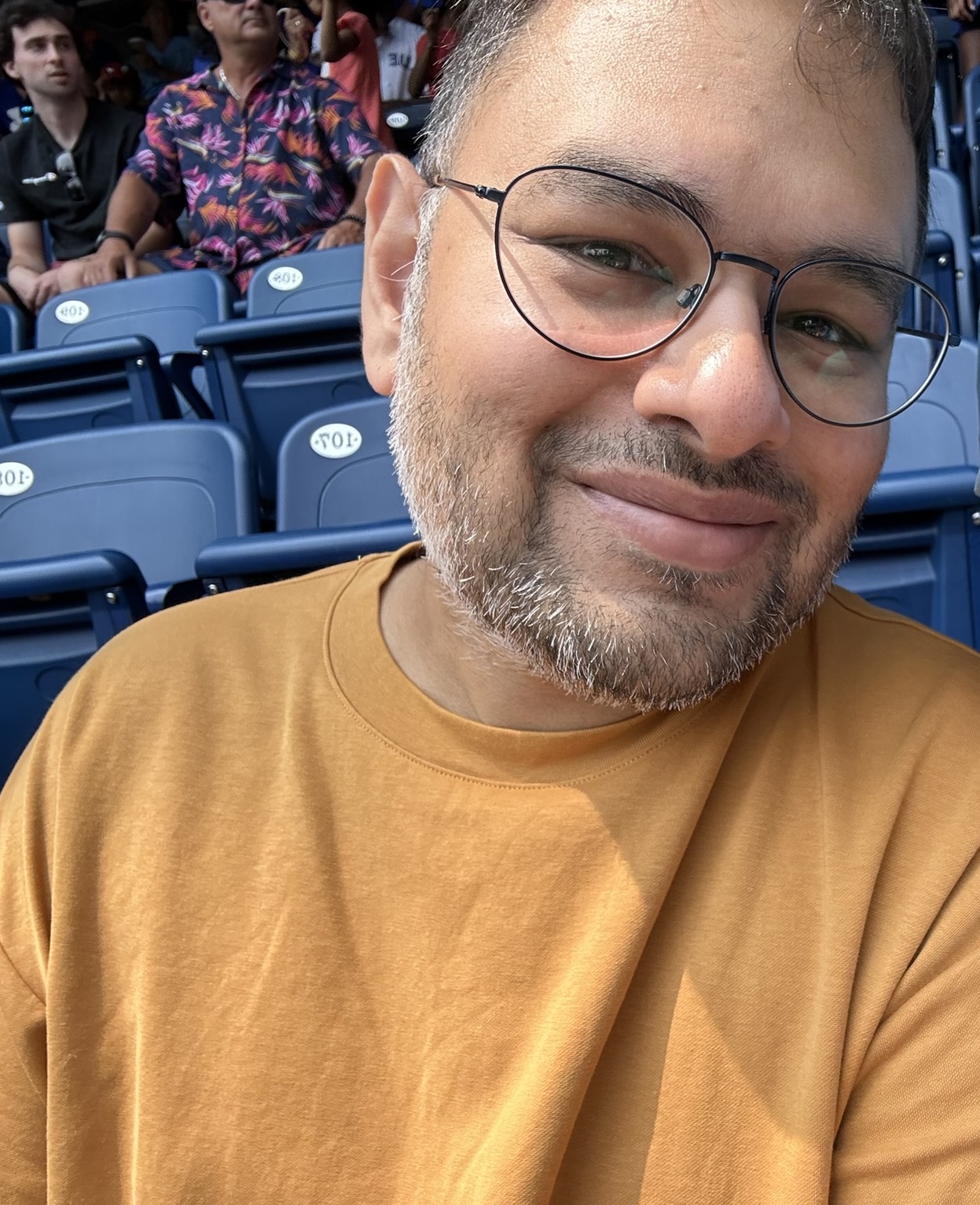 Baseer Baig sitting in a stadium.