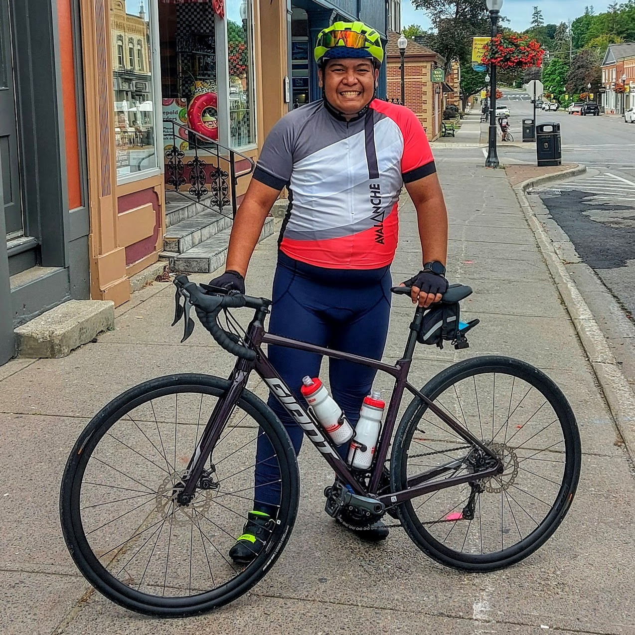 Jose standing on the sidewalk with his bike.