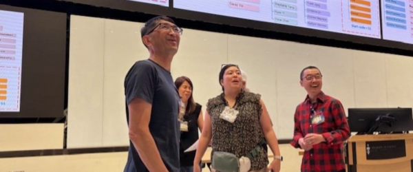 Staff members smiling at the team event